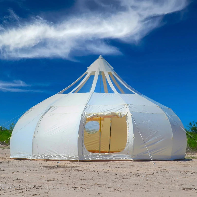 Wilderness Resource Astral Glamping Tent pictured on sand with wispy clouds