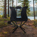 CLIQ EpiQ Lounge chair in black in a forest setting with a lake in the background