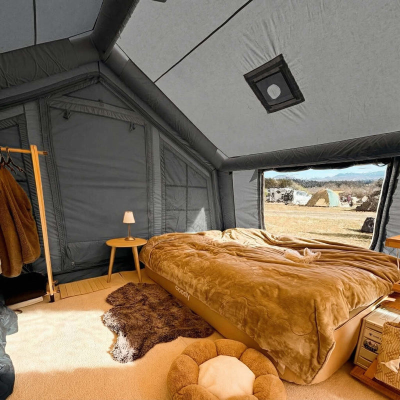Coody 17.2 gray inflatable tent interior view with bed and other amenities.