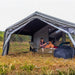 Coody AirTarp gray inflatable canopy with person and furniture.