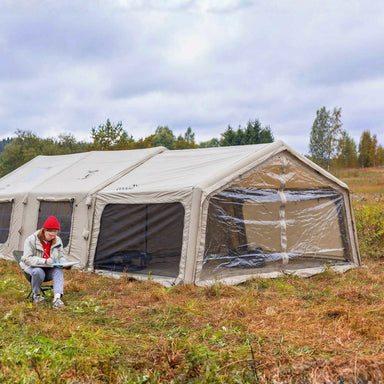 Coody AirTarp Inflatable Canopy extension in beige exterior view with person.