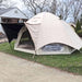 Coody Aurora Dome Inflatable Tent in beige with rain fly set up in yard.