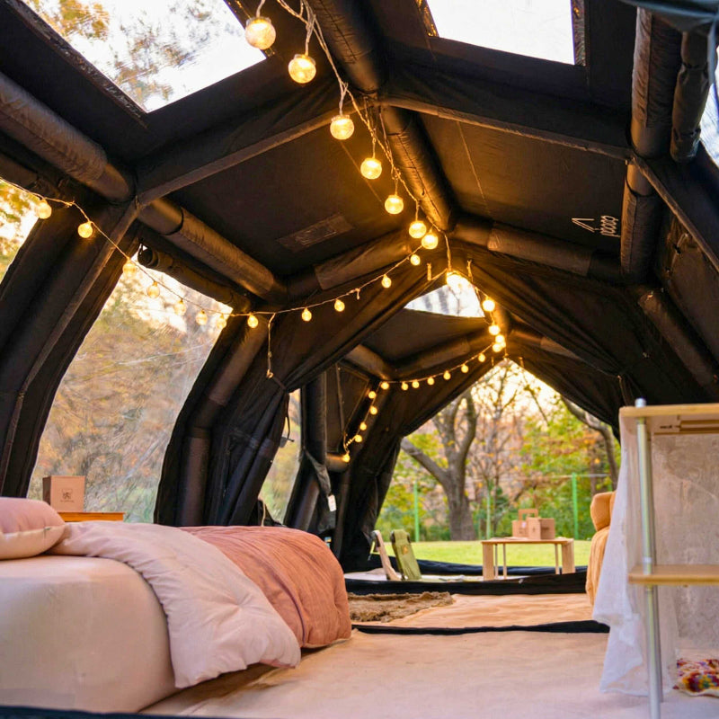 Coody Familia 17.2 Pro black inflatable tent interior living space with furniture. 