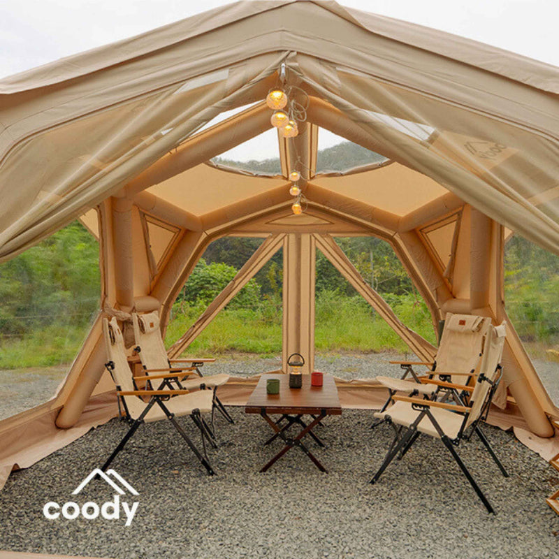 Coody Hub Pro beige inflatable shelter view of interior through door with furniture.