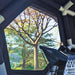 Coody Hub Shelter Pro black inflatable tent interior view of large window with tree outside.