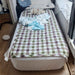 Coody Inflatable air mattress with checkered blanket and clothes in a room setting