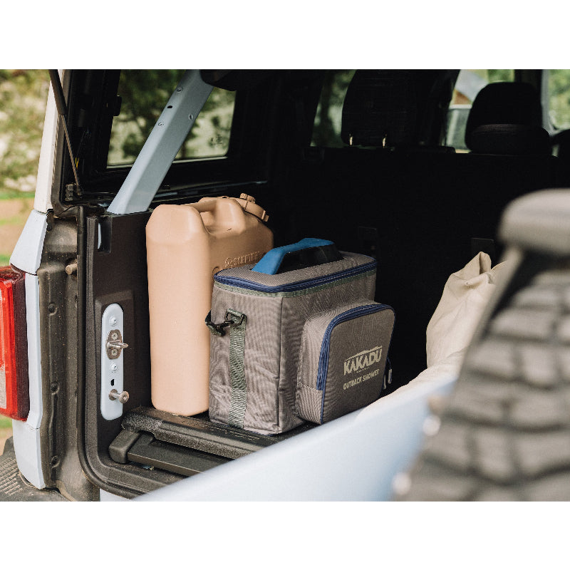 Kakadu Outback Shower Carry Bag in trunk of vehicle