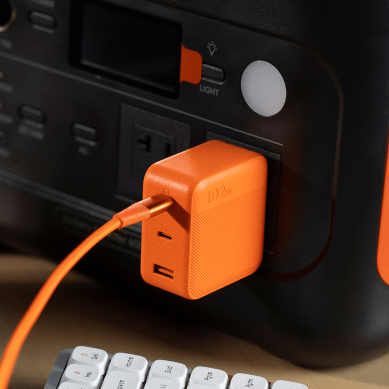 Jackery 102W GaN 3-Port Fast Charger plugged into Jackery Portable Power Station